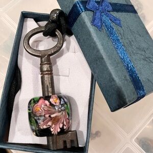 Vintage Key Pendant with Glass Blown Floral Bead encompassing it